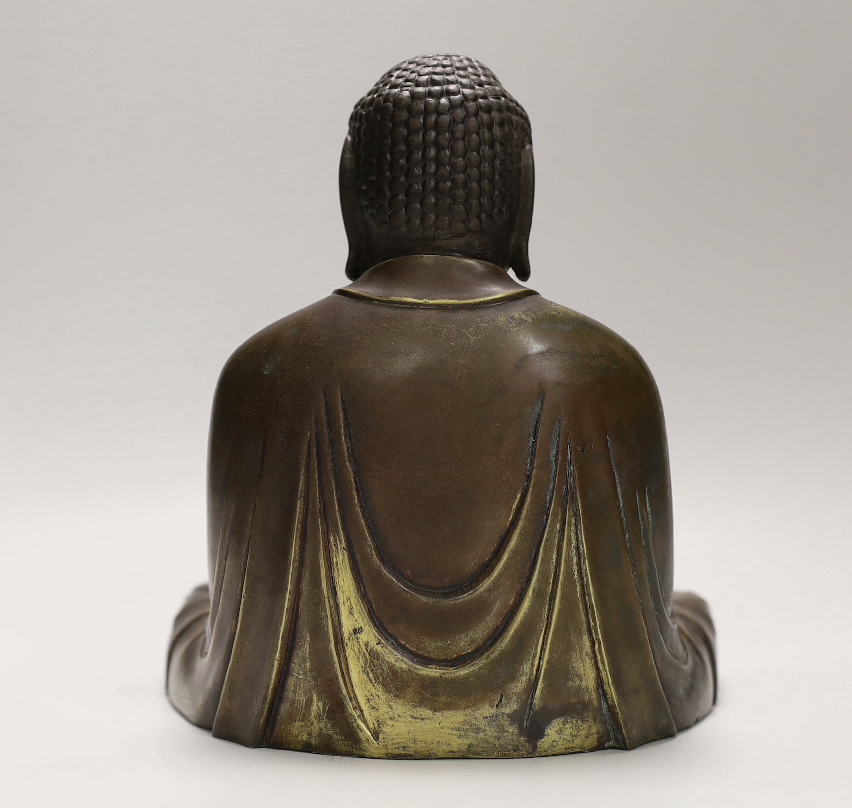 A 20th century bronze model of a seated Buddha, 22cm high
